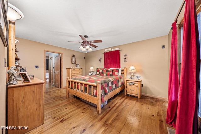 bedroom with baseboards, ceiling fan, visible vents, and light wood-style floors