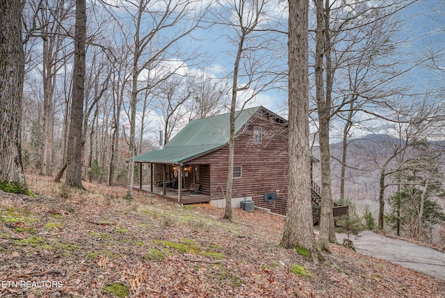 view of home's exterior featuring metal roof and central AC unit