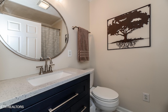 bathroom featuring toilet and vanity