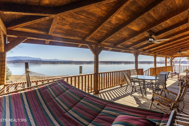 deck featuring ceiling fan and a water and mountain view