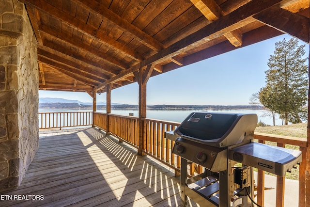 deck featuring grilling area and a water and mountain view