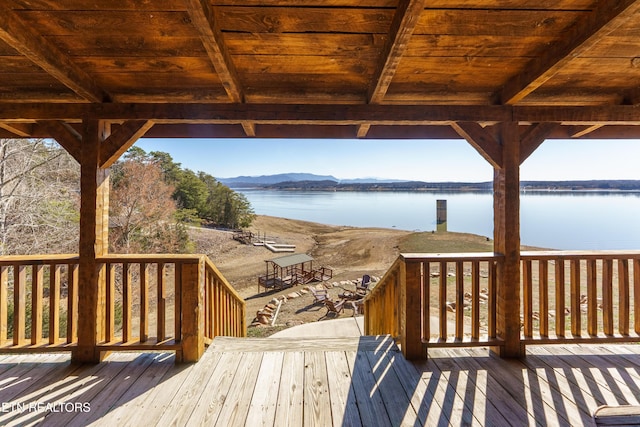 deck with a water and mountain view