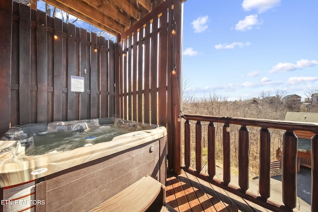 wooden deck featuring a hot tub