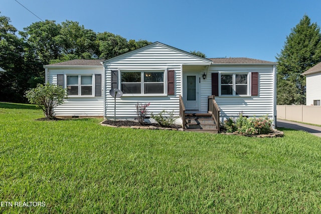 bungalow-style home featuring a front yard, crawl space, and fence