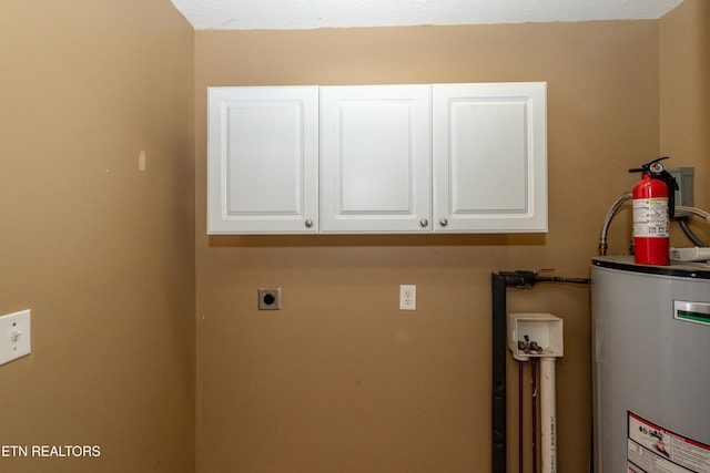 washroom featuring gas water heater, cabinet space, and electric dryer hookup