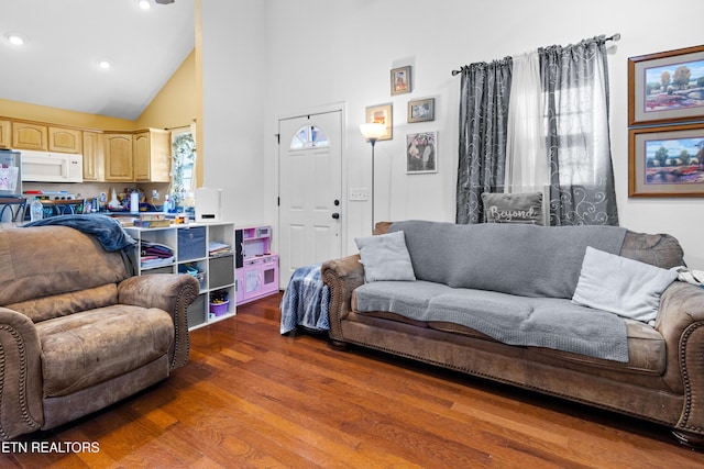 living room featuring dark wood-style floors, high vaulted ceiling, and recessed lighting