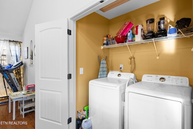 laundry area featuring washer and dryer, laundry area, and wood finished floors