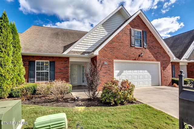 view of front of house with concrete driveway, roof with shingles, an attached garage, a front lawn, and brick siding