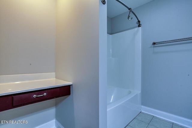 bathroom with baseboards and tile patterned floors