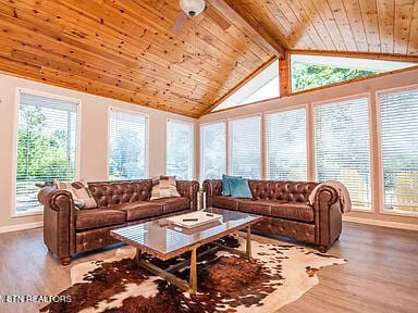 living room with high vaulted ceiling, wood finished floors, wood ceiling, baseboards, and beamed ceiling