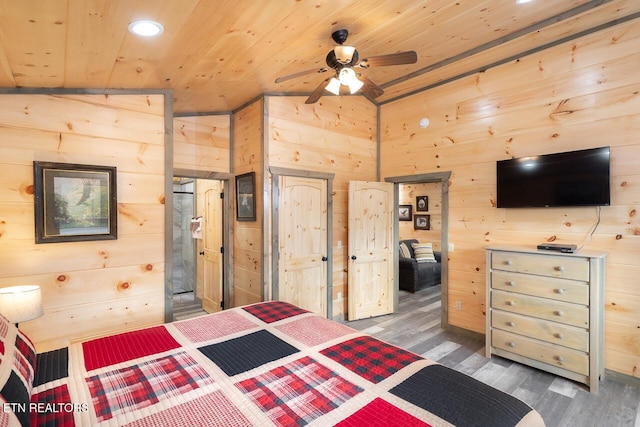 bedroom featuring recessed lighting, wood finished floors, wood ceiling, and wooden walls