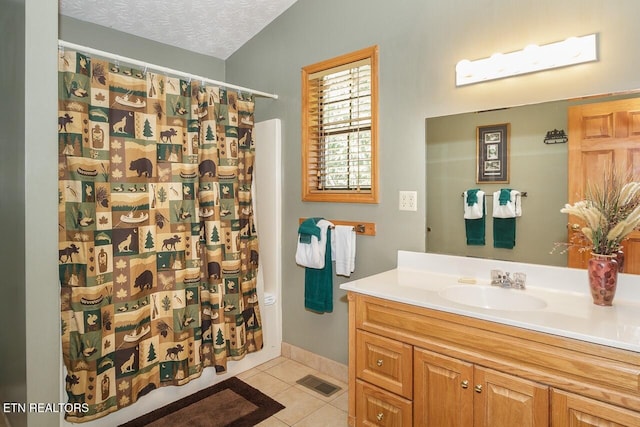 full bath with visible vents, a shower with shower curtain, a textured ceiling, vanity, and tile patterned flooring