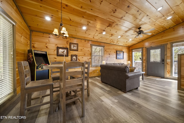 dining area featuring wood walls, wood ceiling, vaulted ceiling, and wood finished floors