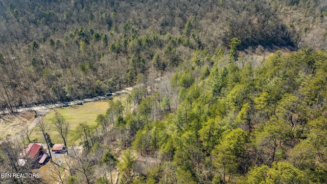 aerial view featuring a wooded view