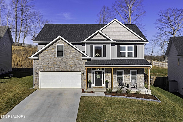 view of front of house with a porch, a front yard, driveway, and board and batten siding