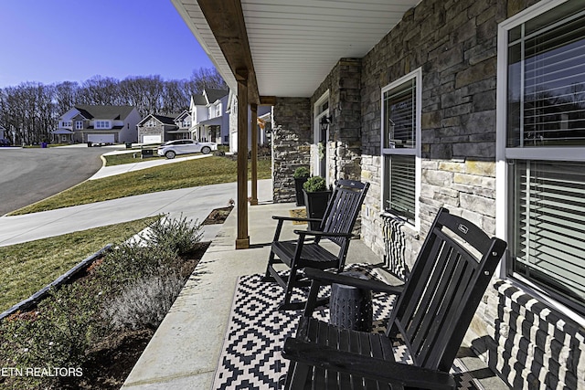 view of patio featuring covered porch and a residential view