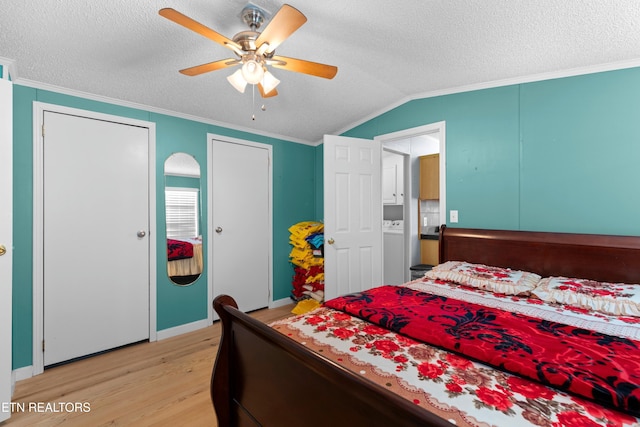 bedroom featuring lofted ceiling, a textured ceiling, light wood-type flooring, and crown molding