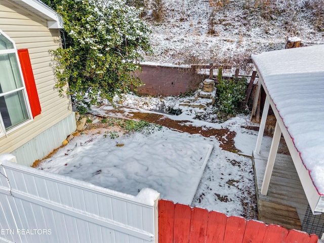 yard layered in snow featuring a fenced backyard