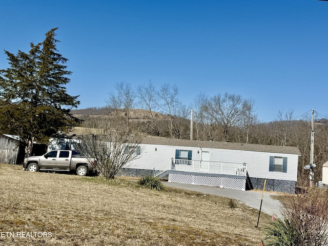 view of front of house with a front lawn and a wooden deck