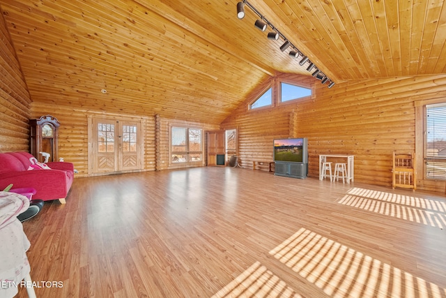 unfurnished living room featuring rail lighting, wood finished floors, high vaulted ceiling, wooden ceiling, and plenty of natural light