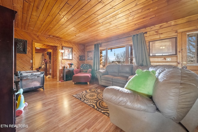 living area with a healthy amount of sunlight, wood walls, wood ceiling, and wood finished floors