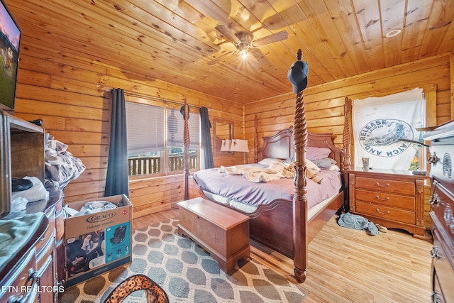 bedroom featuring access to exterior, wooden walls, and wood finished floors