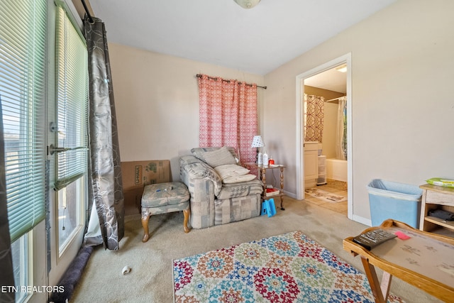 sitting room featuring carpet and baseboards