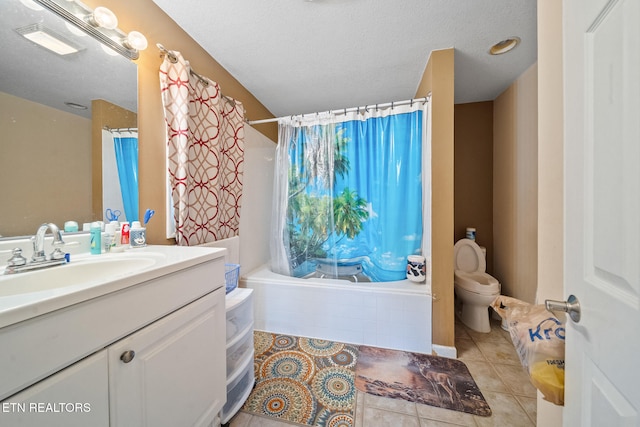 full bathroom with toilet, tiled shower / bath combo, a textured ceiling, vanity, and tile patterned flooring