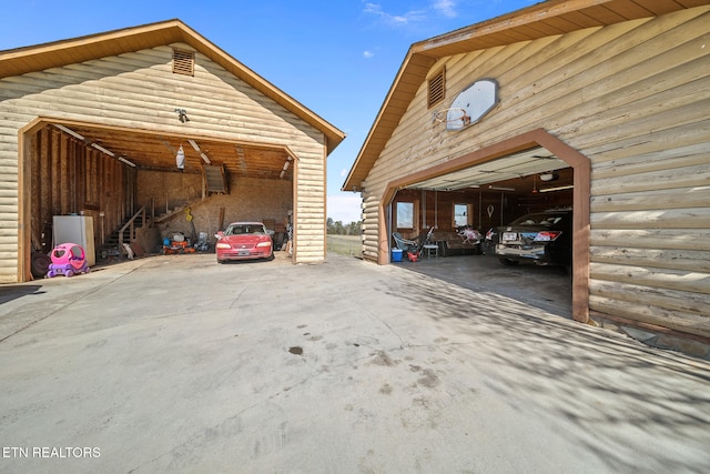 exterior space featuring a garage and an outbuilding