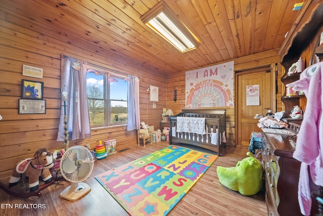 game room featuring wood walls, wood ceiling, and wood finished floors