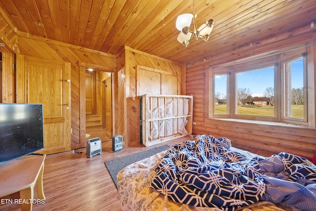 bedroom with a chandelier, wooden ceiling, and wood finished floors