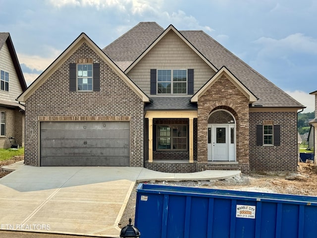 2127 Lantern Park Ln, Knoxville, TN 37932 - view of front of home with brick siding, driveway, roof with shingles, an attached garage, and a porch