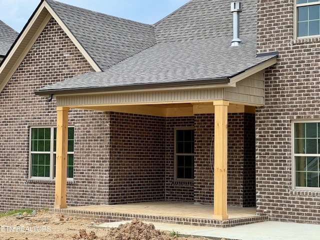 2127 Lantern Park Ln, Knoxville, TN 37932 - view of home's exterior with roof with shingles, brick siding, and a patio area