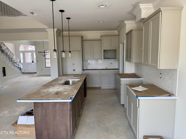 2127 Lantern Park Ln, Knoxville, TN 37932 - kitchen featuring a kitchen island with sink, concrete flooring, tasteful backsplash, crown molding, and pendant lighting