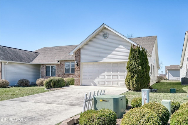 single story home with brick siding, concrete driveway, central AC, a front yard, and an attached garage