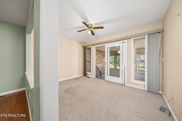 unfurnished room featuring visible vents, baseboards, carpet floors, and a ceiling fan