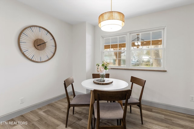 dining room featuring baseboards and wood finished floors