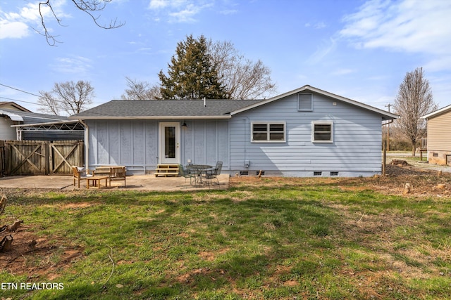 back of property featuring fence, entry steps, a patio area, crawl space, and a lawn