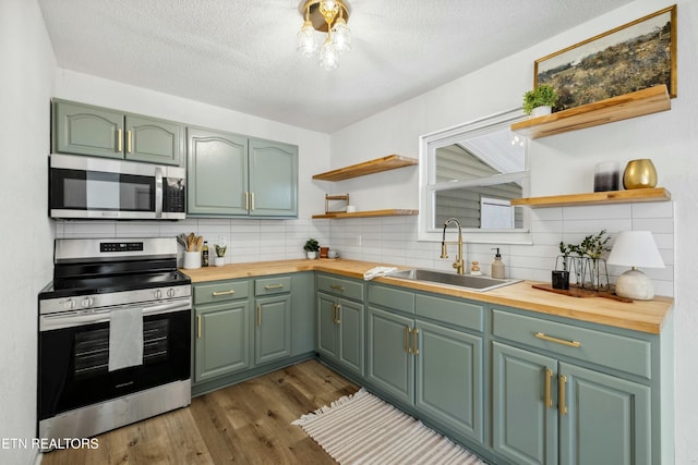 kitchen featuring open shelves, appliances with stainless steel finishes, and butcher block countertops