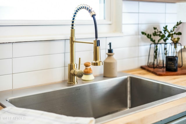 room details with tasteful backsplash and a sink