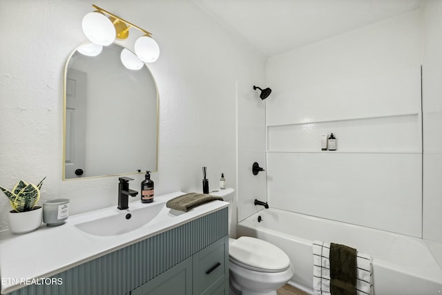 full bath with shower / bathing tub combination, toilet, vanity, and a textured wall