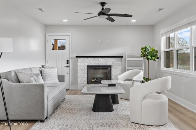 living area with recessed lighting, baseboards, and wood finished floors