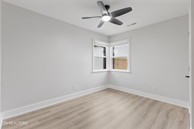 unfurnished room with visible vents, baseboards, light wood-style floors, and ceiling fan