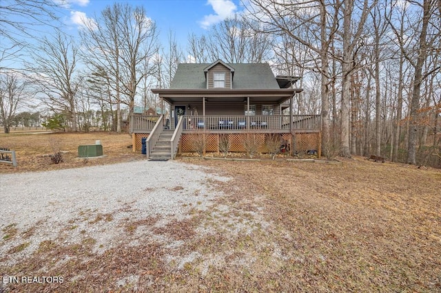 chalet / cabin featuring a porch and stairway