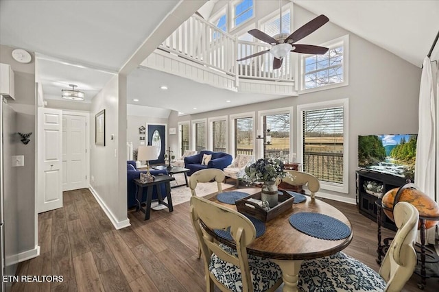 living room with ceiling fan, high vaulted ceiling, recessed lighting, baseboards, and dark wood-style floors