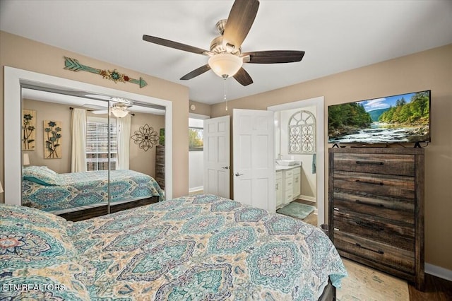 bedroom with a ceiling fan, a closet, light wood-style flooring, and baseboards