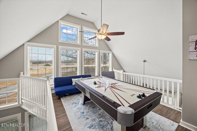 playroom featuring lofted ceiling, ceiling fan, visible vents, and wood finished floors