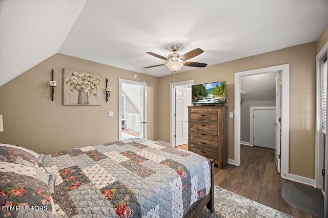 bedroom featuring lofted ceiling, dark wood finished floors, a ceiling fan, and baseboards