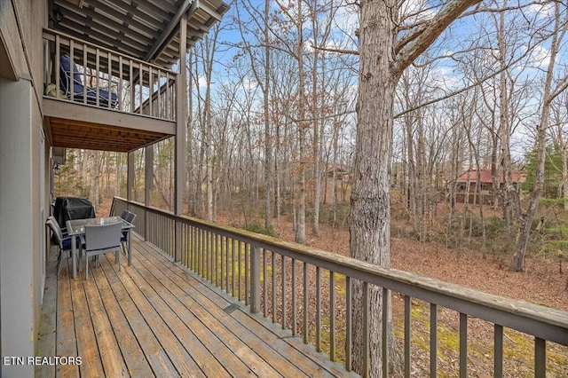 wooden terrace with outdoor dining space