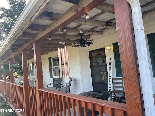 property entrance featuring covered porch and ceiling fan